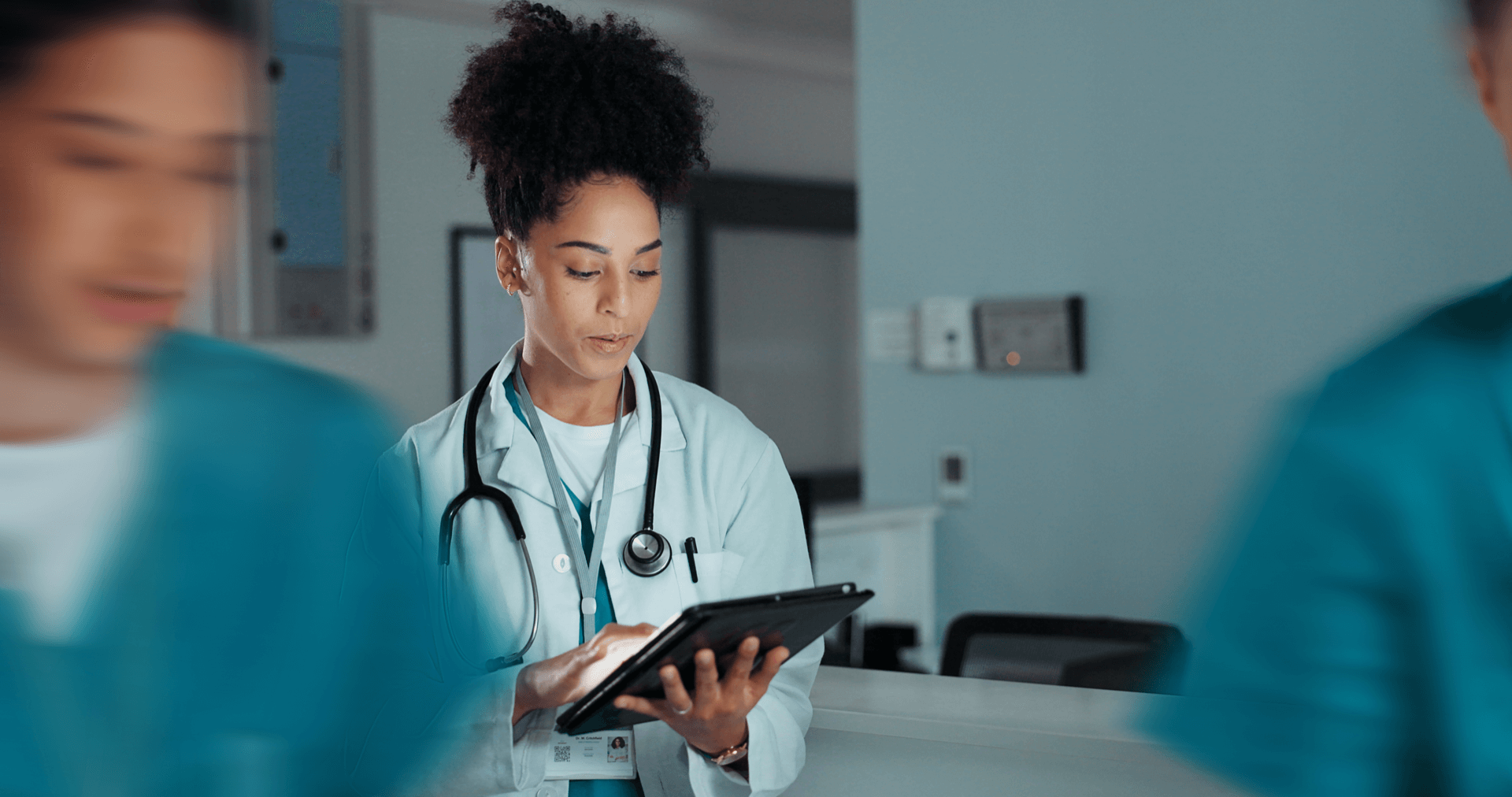 A healthcare professional reading a document in a hospital setting.
